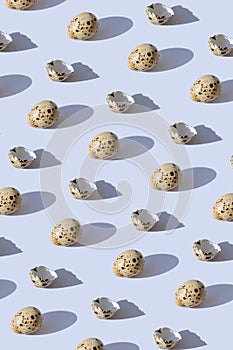 Minimal style pattern made of quail eggs on pastel background with shadow. Easter creative concept