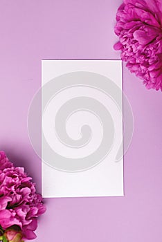 Minimal Styled Flat lay with Pink Peony flowers and white blank Mock up top view Horizontal