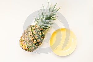 Minimal summer healthy food fruits creative concept made of pineapple and pastel empty plate isolated on white background .Top vie