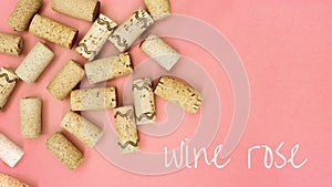 Minimal trendy concept with corks from wine bottles on pink paper background