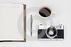 Minimal white work space with vintage style camera