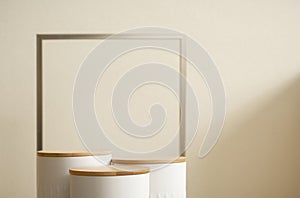 Minimal wood white podium with blurred golden frame on gold beige background.Beauty cosmetic new product modern display,luxury