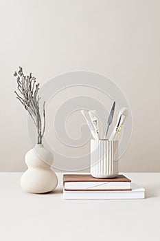 Minimal workspace with paint brushes and a vase