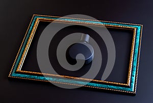 Black matte bottle for unisex perfume close-up inside emerald frame with gold border on a dark background, mock up