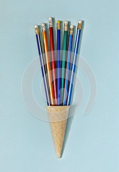 Minimalism. Ice cream cone, art, colorful pencils,fun, business concept. top view. copy space