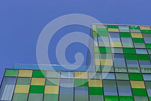 Minimalism in street photography. Green glass office building against the blue sky. Modern design and straight lines - urban