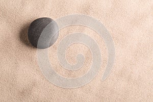 Minimalism zen background with black stone in sand