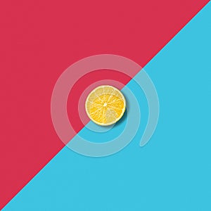 Minimalist abstract with single lemon slice on vibrant colorful background