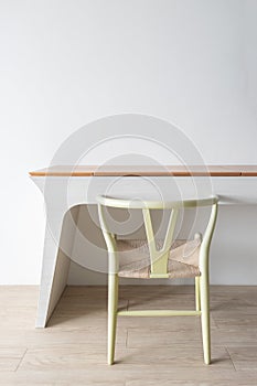 Minimalist architect designer concept with green classic chair and modern table on wooden floor with white wall background