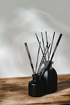 Minimalist Aromatic Reed Diffusers on a Wooden Surface Against a Soft Background photo