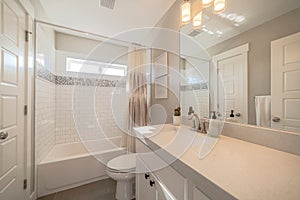 Minimalist bathroom interior with built in bathtub toilet and vanity area