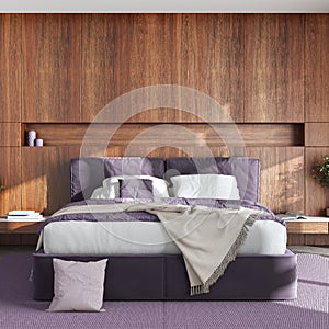 Minimalist bedroom with wooden headboard in white and violet tones. Velvet bed, bedding, pillows and carpet. Contemporary interior