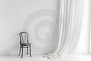 Minimalist black chair against white background
