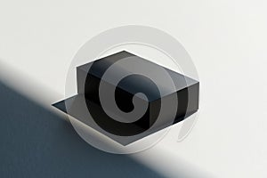 Minimalist black rectangular prism object casting shadow on a plain white background surface