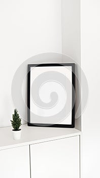 Minimalist black white picture frame with Christmas tree decor. Interior poster mock-up