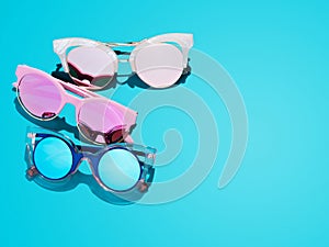 Minimalist blue banner with many old fashioned sunglasses.