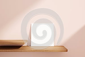 Minimalist and clean square white poster or photo frame mockup on the wooden table leaning against the room wall