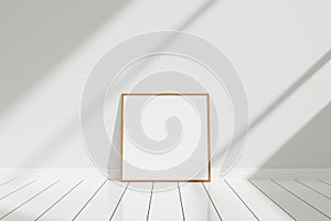 Minimalist and clean square wooden poster or photo frame mockup on the floor leaning against the room wall with shadow