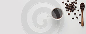 A minimalist coffee background with a single cup of black coffee on a clean, white surface photo