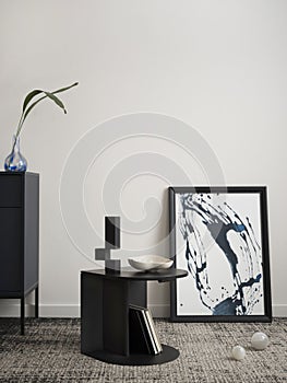 Minimalist composition of elegant and outstanding space with mock up poster frame, dark coffee table, decoration, book, stylish