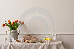 Minimalist composition of living room nterior with copy space, vase with tulips, bread in basket, colorful easter eggs, easter