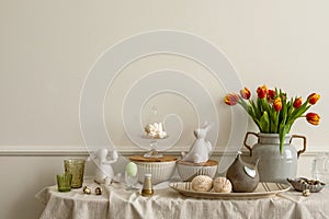 Minimalist composition of living room nterior with copy space, vase with tulips, bread in basket, colorful easter eggs, easter