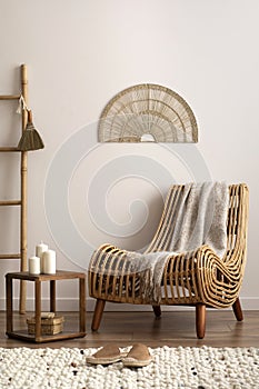 Minimalist composition of meditation living room interior with armchair, beige carpet, pillows, ornament and personal accessories