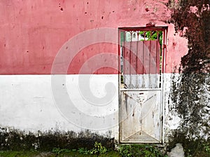 Minimalist door on the old red and white wall