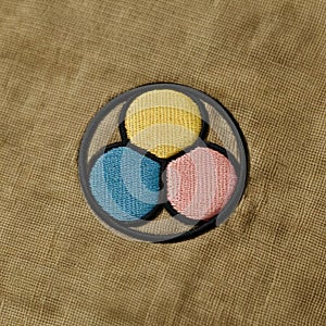 A minimalist embroidered patch on a smooth canvas fabric photo