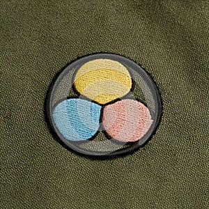 A minimalist embroidered patch on a smooth canvas fabric photo