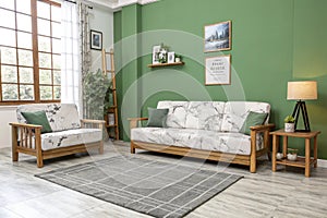 Minimalist green wall with modern sofa and marble patterns