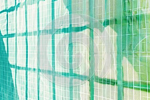 Minimalist grid patterns in light blue and green, representing structure and order