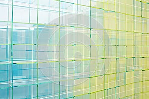 Minimalist grid patterns in light blue and green, representing structure and order