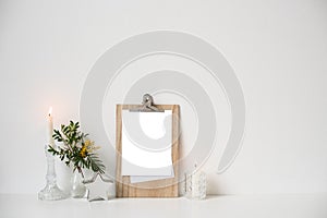 Minimalist home decor with empty frame mock-up on white wall background