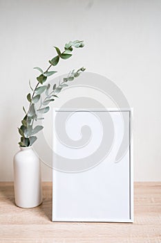 Minimalist home decor with empty frame mock-up on white wall background