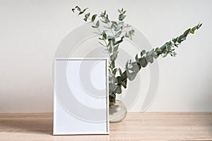 Minimalist home decor with empty frame mock-up on white wall background