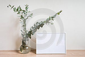 Minimalist home decor with empty frame mock-up on white wall background