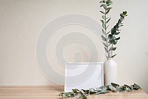 Minimalist home decor with empty frame mock-up on white wall background