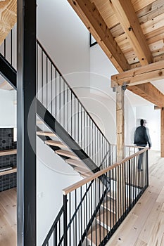 minimalist interior design, white walls with wooden beams on the ceiling, wood staircase, light brown stairs handrail