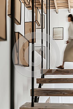 minimalist interior design, white walls with wooden beams on the ceiling, wood staircase, light brown stairs handrail