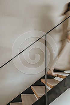 minimalist interior design, white walls with wooden beams on the ceiling, wood staircase, light brown stairs handrail