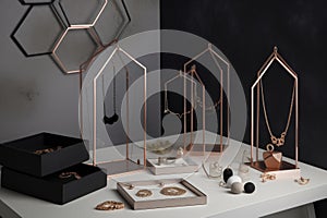 a minimalist jewelry display featuring simple, single-piece necklaces and earrings