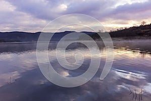Minimalist landscape with reflections in the water of a lake