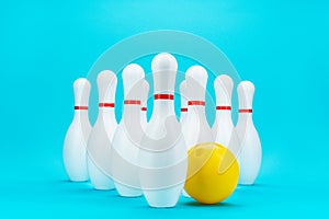 Minimalist photo of bowling pins over turquoise blue background