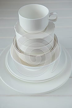 Minimalist picture of white porcelain kitchenware piled up