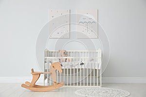 Minimalist room with baby crib, decor elements and toys