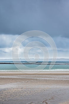 Minimalist sandy beach on a cloudy day