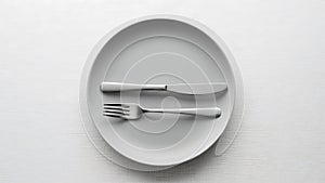 Minimalist setting empty plate with fork and knife silverware