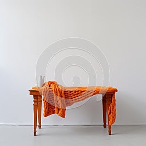 Minimalist Still Life: Bright Orange Knitted Table In Empty White Space