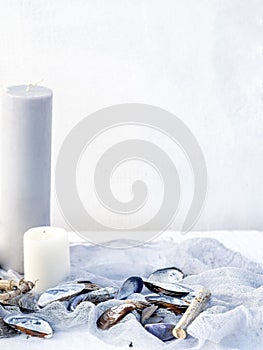 Minimalist summer background created by candles and shells.